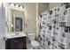 Bathroom with a vanity, toilet, and shower with a patterned shower curtain at 1011 Potomac Rd, Indian Trail, NC 28079