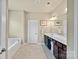 Neutral bathroom with dark cabinets, a soaking tub, and a large mirror at 1011 Potomac Rd, Indian Trail, NC 28079
