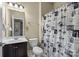 Bathroom with a vanity, toilet, and bathtub with a creative city-themed shower curtain at 1011 Potomac Rd, Indian Trail, NC 28079