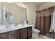 Bathroom featuring a double sink vanity, toilet, and shower with a curtain at 1011 Potomac Rd, Indian Trail, NC 28079