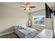 Bright bedroom features a ceiling fan, neutral walls, and a large window with blinds at 1011 Potomac Rd, Indian Trail, NC 28079