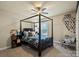 Cozy bedroom with a four-poster bed, ceiling fan, and carpet flooring at 1011 Potomac Rd, Indian Trail, NC 28079