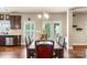 Open dining area showcasing elegant lighting, backyard views, and stainless steel appliances at 1011 Potomac Rd, Indian Trail, NC 28079
