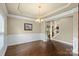 Elegant dining room with hardwood floors, wainscoting, and a chandelier at 1011 Potomac Rd, Indian Trail, NC 28079