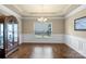 Elegant dining room showcasing wainscoting, hardwood floors, and a classic chandelier fixture at 1011 Potomac Rd, Indian Trail, NC 28079