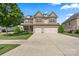 Charming two-story home with a well-manicured lawn and a two-car garage at 1011 Potomac Rd, Indian Trail, NC 28079