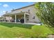 Rear exterior showcasing the large covered patio, lush lawn, and a two-story home at 1011 Potomac Rd, Indian Trail, NC 28079