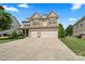 Charming two-story home with a well-manicured lawn and a two-car garage at 1011 Potomac Rd, Indian Trail, NC 28079