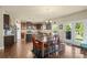 Open concept kitchen and dining area showcasing hardwood floors, a center island, and stainless steel appliances at 1011 Potomac Rd, Indian Trail, NC 28079