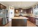 Open kitchen with dark wood cabinets, granite countertops, and stainless steel appliances at 1011 Potomac Rd, Indian Trail, NC 28079