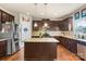 Beautiful kitchen with granite counters, dark wood cabinets, stainless appliances and center island at 1011 Potomac Rd, Indian Trail, NC 28079