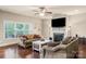 Bright living room with fireplace, hardwood floors, comfortable sofas, and large windows at 1011 Potomac Rd, Indian Trail, NC 28079
