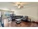 Spacious living room with hardwood flooring and a large, comfortable leather sectional sofa at 1011 Potomac Rd, Indian Trail, NC 28079