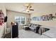 Living room features a ceiling fan, neutral walls, and a window with blinds at 1011 Potomac Rd, Indian Trail, NC 28079