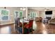 Open concept living and dining area with a fireplace, hardwood floors, and backyard views at 1011 Potomac Rd, Indian Trail, NC 28079