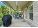 Covered outdoor patio with ample seating, ceiling fans, and a grill at 1011 Potomac Rd, Indian Trail, NC 28079