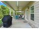 Covered patio with ceiling fans, furniture set and grill, perfect for outdoor entertaining at 1011 Potomac Rd, Indian Trail, NC 28079