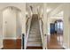 View of the carpeted staircase with wooden handrails leading to the upper level of the house at 1011 Potomac Rd, Indian Trail, NC 28079