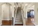 Traditional staircase with carpeted steps and decorative wrought iron railing at 1011 Potomac Rd, Indian Trail, NC 28079