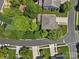 An aerial shot shows the home has mature trees and landscaping, a driveway, and is located on a quiet street at 1012 Sudbury Ln, Matthews, NC 28104