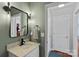 Stylish half bathroom featuring quartz countertop, modern fixtures, and a decorative mirror at 1012 Sudbury Ln, Matthews, NC 28104