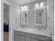 Bathroom featuring a double vanity with gray cabinetry, marble countertops, and modern fixtures at 1012 Sudbury Ln, Matthews, NC 28104
