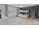 Bedroom featuring a bunk bed, ceiling fan, and windows with white plantation shutters at 1012 Sudbury Ln, Matthews, NC 28104