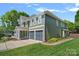 Charming home featuring a two-car garage, well-manicured landscaping, and inviting front porch at 1012 Sudbury Ln, Matthews, NC 28104