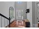 Bright foyer with high ceilings, hardwood floors, and a decorative mirror at 1012 Sudbury Ln, Matthews, NC 28104