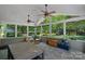 Enclosed sunroom features a slate floor, wood furniture, and views of the landscaped backyard at 1012 Sudbury Ln, Matthews, NC 28104