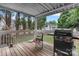 Cozy back porch featuring a grill and views of the green backyard and a charming shed at 103 Pine Meadows Cir, Hickory, NC 28601