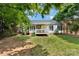 Backyard with a cozy porch and lush green grass at 103 Pine Meadows Cir, Hickory, NC 28601