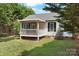 Backyard with a cozy porch and lush green grass at 103 Pine Meadows Cir, Hickory, NC 28601