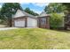 A single-story brick home featuring a well-manicured lawn and an attached two-car garage at 103 Pine Meadows Cir, Hickory, NC 28601