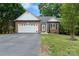 Charming single-story brick home with a well-maintained lawn and attached two-car garage at 103 Pine Meadows Cir, Hickory, NC 28601