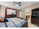 Spacious bedroom with a large bed, a ceiling fan and a bathroom through a door at 103 Pine Meadows Cir, Hickory, NC 28601