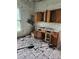 Kitchen space awaiting transformation, featuring a window and wood cabinets, ready for a modern renovation at 105 E Second Ave, Mount Gilead, NC 27306