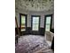 Interior room with three windows, offering potential for renovation with natural light and architectural character at 105 E Second Ave, Mount Gilead, NC 27306