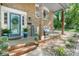 Charming front porch with brick accents, decorative plants, and comfortable seating area at 1110 16Th Avenue Nw Pl, Hickory, NC 28601
