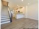 Open-concept living space featuring modern flooring, recessed lighting, and staircase leading to the next level at 1116 Bismuth Way, Charlotte, NC 28211