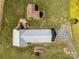 Aerial view showcasing the home's layout, metal roof, and surrounding green space and landscaping at 1160 Redmon Rd, Cleveland, NC 27013