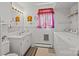 Bathroom featuring tiled walls, vanity, mirror and included washer and dryer at 1160 Redmon Rd, Cleveland, NC 27013