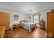 Comfortable bedroom with wood floors, natural light, and classic furnishings at 1160 Redmon Rd, Cleveland, NC 27013