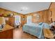 Traditional bedroom with hardwood floors, wood paneling, and ample natural light at 1160 Redmon Rd, Cleveland, NC 27013
