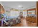 Bright bedroom featuring hardwood floors, large windows, and classic wood furniture at 1160 Redmon Rd, Cleveland, NC 27013