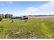 Sprawling ranch-style house on a large, well-maintained green lawn with mature trees and agricultural fields at 1160 Redmon Rd, Cleveland, NC 27013
