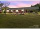 Charming brick home features a covered carport and a lush, expansive front lawn at 1160 Redmon Rd, Cleveland, NC 27013