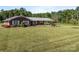 Brick home with a large front yard, beautiful landscaping, and mature trees at 1160 Redmon Rd, Cleveland, NC 27013