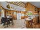 Functional kitchen adjacent to the dining area, featuring wood paneling and essential appliances at 1160 Redmon Rd, Cleveland, NC 27013
