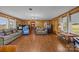 Open-concept living room featuring hardwood floors, wood paneling, and comfortable seating at 1160 Redmon Rd, Cleveland, NC 27013